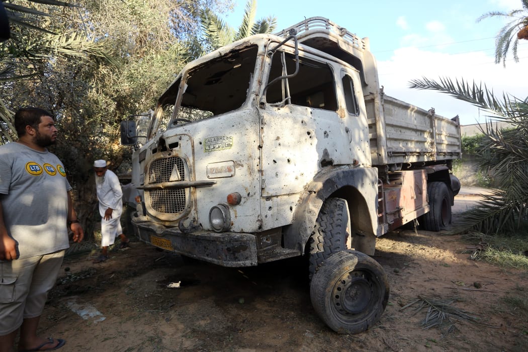 Libyans gather at the site where a mortar shell landed in the capital Tripoli on August 30, 2018.