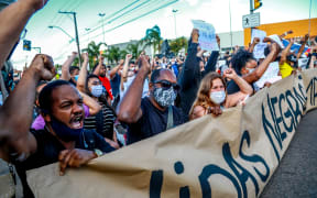 People protest against the death of a black man in front of supermarket Carrefour, where his beating took place, in Porto Alegre, Rio Grande do Sul, Brazil.