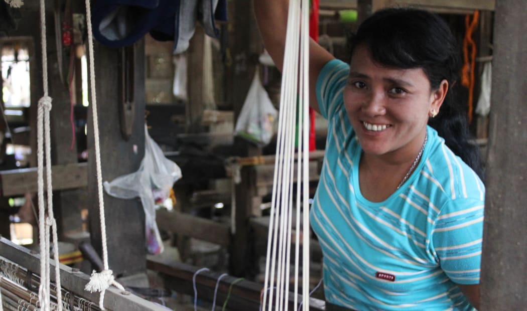 Cing Din Nuam, a weaver who's business has been supported by microfinance.