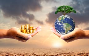 The left hand holds money. Right hand holding a earth There is a bokeh background. Design concept Nature or capitalism. element of the picture is decorated by NASA