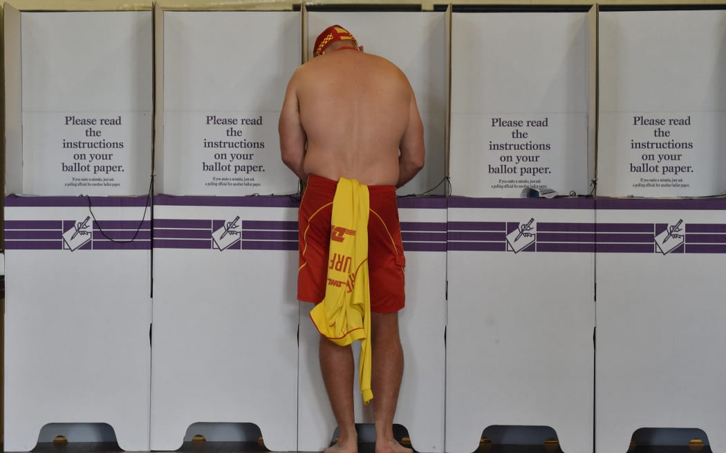 A surf lifesaver casts his ballot in the Wentworth by-election in Bondi Beach in Sydney on October 20, 2018.