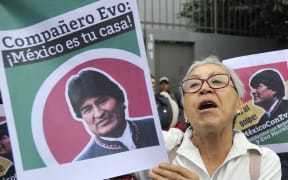 People demonstrate in support of Bolivian ex-President Evo Morales in front of the Bolivian embassy in Mexico City.