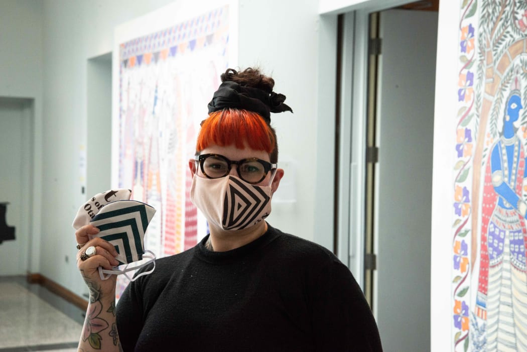 Otago Museum exhibitions and creative services officer Prudence Jopson and her masks crafted from recycled merchandise.