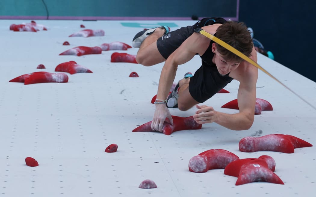 An overview shows New Zealand's Julian David competing in the men's sport climbing speed preliminary round during the Paris 2024 Olympic Games at Le Bourget Sport Climbing Venue in Le Bourget on August 6, 2024. (Photo by POOL / AFP)