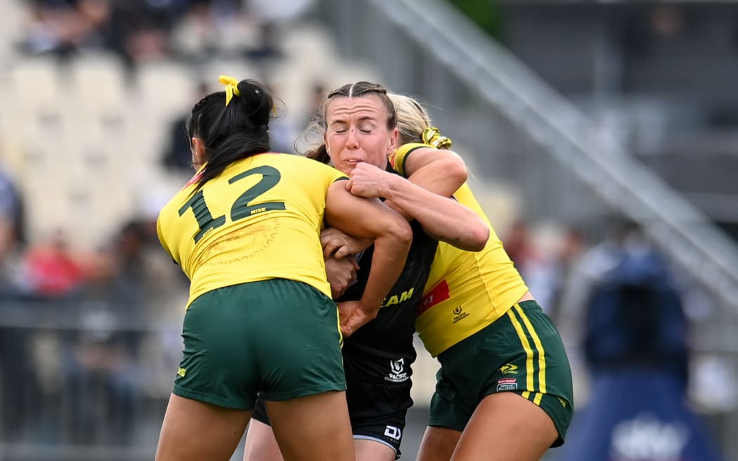 Georgia Hale (C) of the Kiwi Ferns is tackled by Yasmin Clydsdale of the Jillaroos during the Pacific Rugby League Championship.