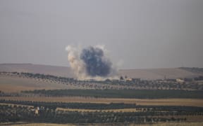 The photo taken from Karkamis district of the Turkey's Gaziantep province shows smoke rising as the Turkish fighter jets bomb Daesh targets in Jarabulus, Syria on August 24, 2016.