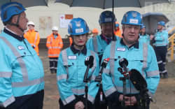 Prime Minister Christopher Luxon, right, speaks to media at Marsden Point, with Finance Minister Nicola Willis, centre, and Associate Minister for Energy Shane Jones, left, on 7 July 2026.