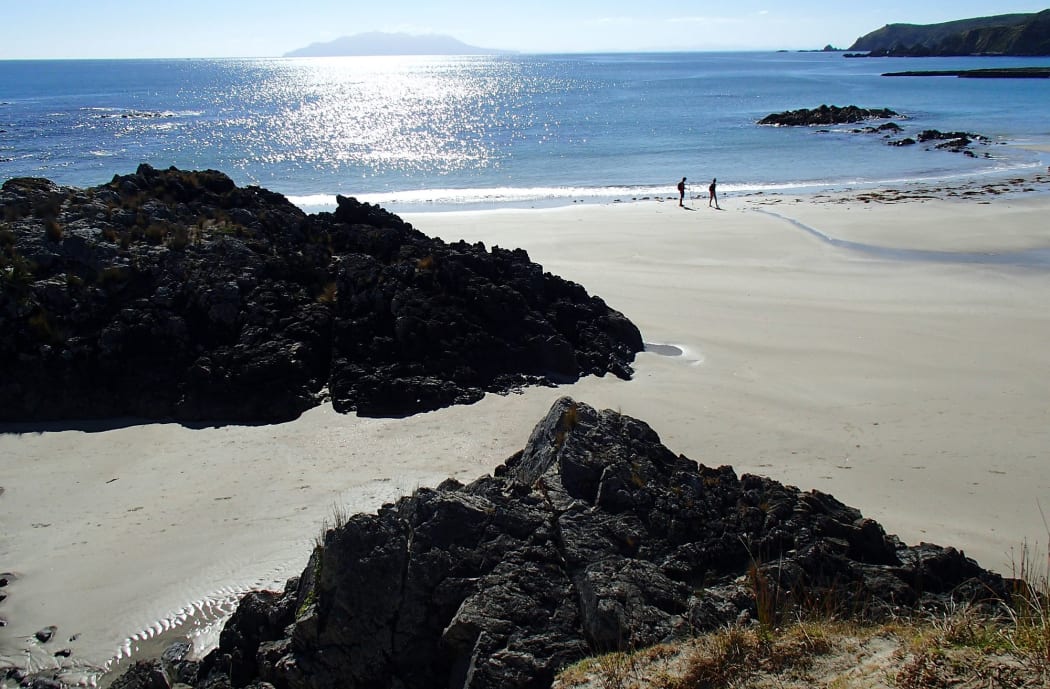 View across beach and sea towards an island