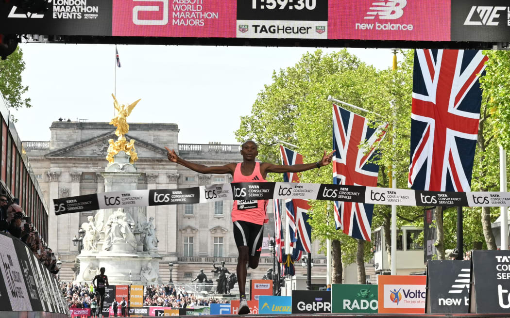 Kenya's Sabastian Sawe crosses the line to win the men's London Marathon race in a new world record time.