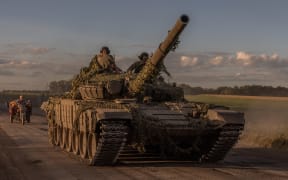 Ukrainian servicemen operate a Soviet-made T-72 tank in the Sumy region, near the border with Russia, on August 12, 2024, amid the Russian invasion of Ukraine. Ukraine launched a surprise offensive into the Russian border region of Kursk on August 6, 2024, capturing over two dozen towns and villages in the most significant cross-border attack on Russian soil since World War II. Ukraine's military chief Oleksandr Syrsky told President Volodymyr Zelensky in a video posted on August 12, 2024 that his troops now control about 1,000 square kilometres of Russian territory and are continuing "offensive operations". (Photo by Roman PILIPEY / AFP)