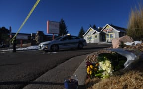 A bouquet of flowers is left near Club Q, an LGBTQ nightclub in Colorado Springs, where a gunamn killed five people on 20 November 2022.