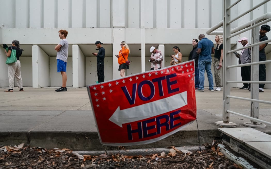 People wait in line to vote on the last day of early voting at the High Museum of Art in Atlanta, Georgia, on November 1, 2024. (Photo by Elijah Nouvelage / AFP)