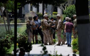 A man is detained by US Marines and members of the National Guard at the Wilshire Federal Building in Los Angeles, California, on June 13, 2025. A judge has ordered Donald Trump to return control of the California National Guard to the state, saying the president's decision to deploy them to protest-hit Los Angeles over Governor Gavin Newsom's objections was "illegal." Protests against Trump's harsh immigration policies spread on June 11 across the United States despite a military-backed crackdown in Los Angeles and threats by the hard-right Republican president to use "heavy force." (Photo by Etienne LAURENT / AFP)