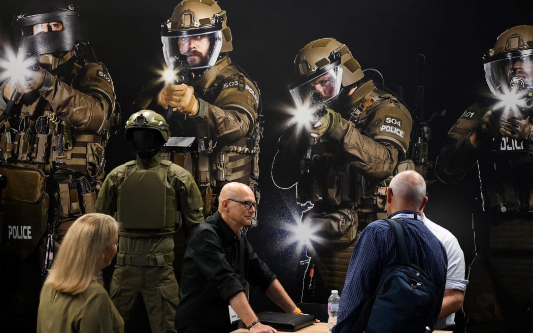 Visitors look at rifles during the Defence and Security Equipment International (DSEI) fair in London, on 12 September, 2023.