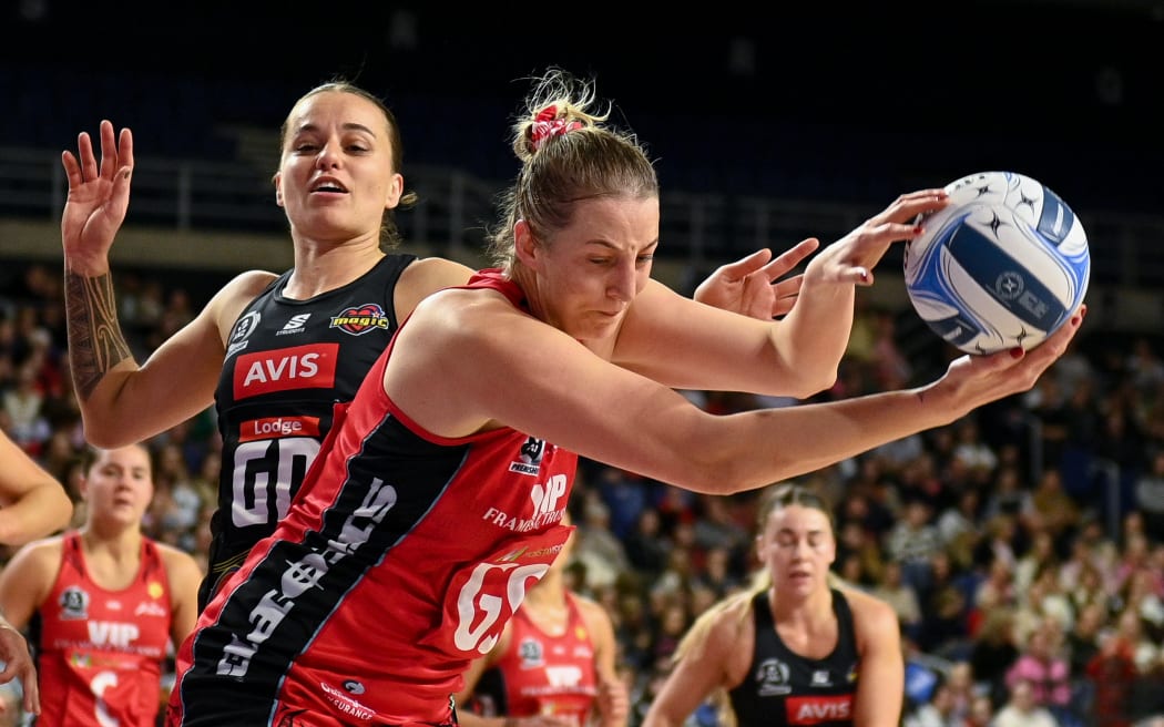 Ellie Bird controls the ball for the Tactix under challenge from Georgia Tong of the Magic during the ANZ Premiership netball match in  Christchurch, 7 July 2025. Copyright photo: John Davidson / www.photosport.nz