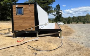 A metal veranda on a converted shipping container tiny home has collapsed at Te Pohue camp ground, injuring several people