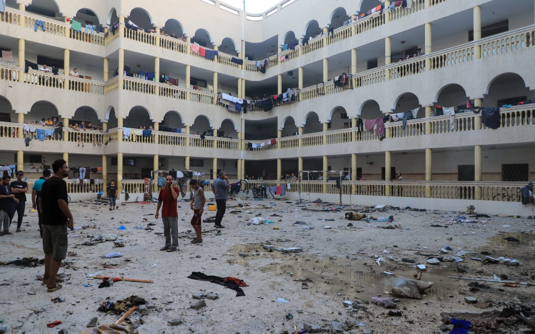 Palestinians gather in the yard of the school after an Israeli strike at the Et-Tabiin where displaced Palestinians took shelter in Gaza City on August 10, 2024. More than 90 people were reported killed, and dozens of others were injured. (Photo by Abood Abusalama / Middle East Images / Middle East Images via AFP)