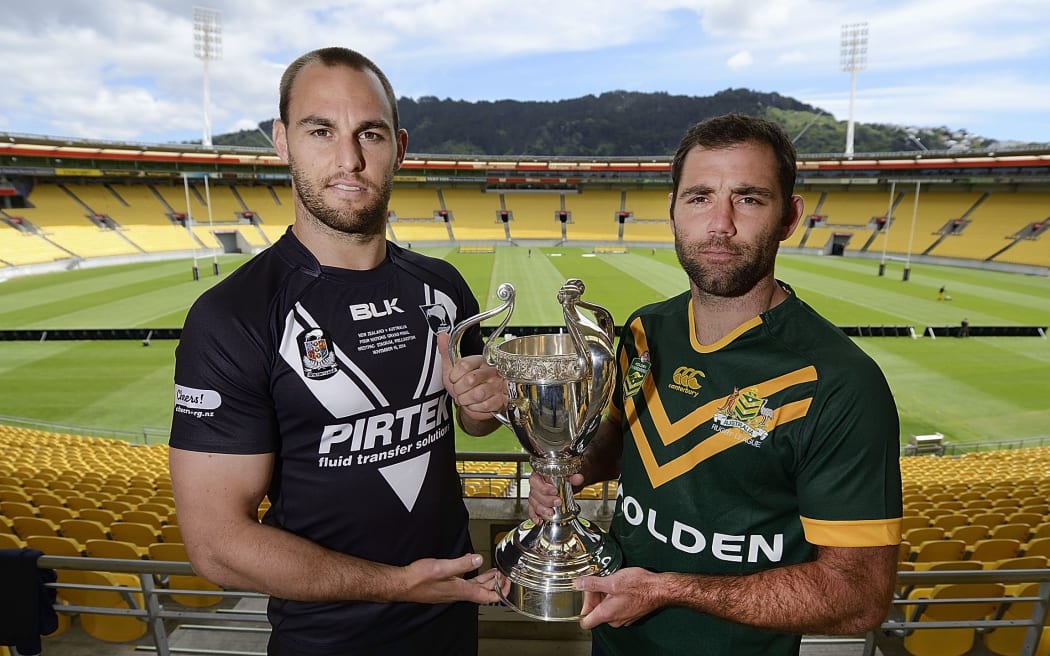 Kiwis captain Simon Mannering and Kangaroos captain Cameron Smith hold the Four Nations trophy.