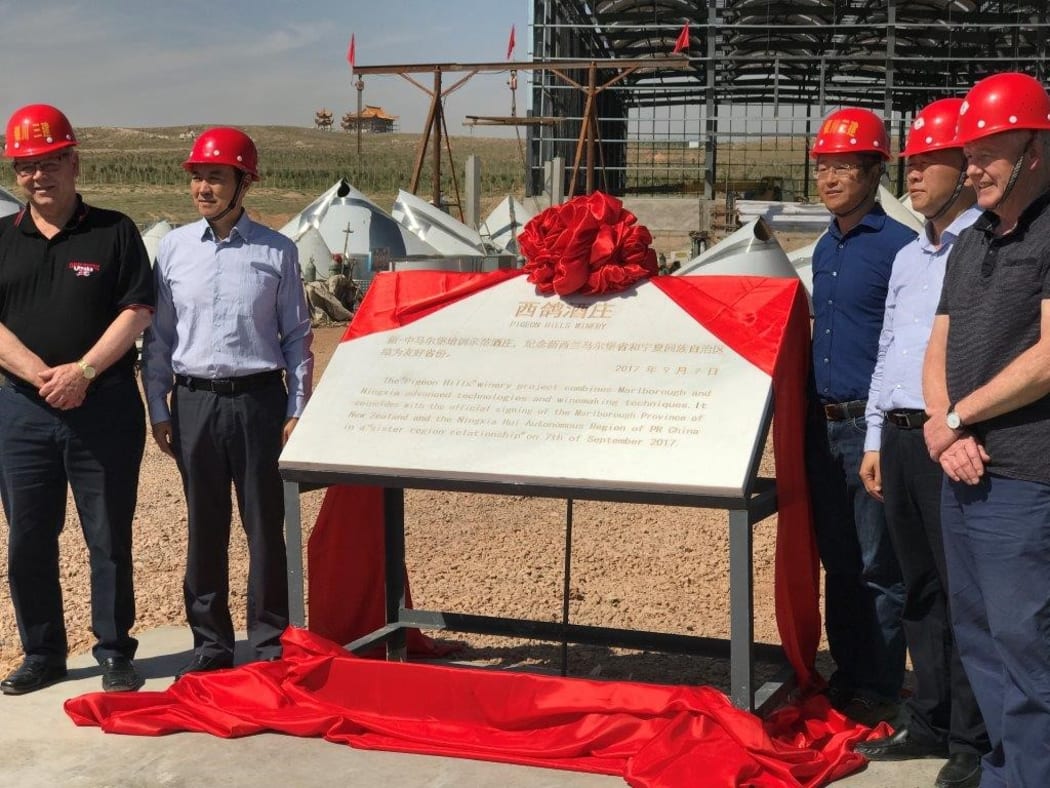 Marlborough District Council Mayor John Leggett  and other delegates unveil a plaque in China.