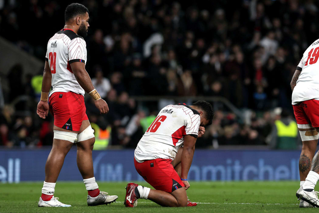 Tonga's Siua Maile (c) is dejected after the game against England.