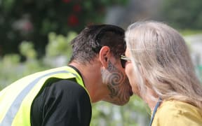 Local Māori warden greeting whānau outside Te Mānuka Tūtahi marae.