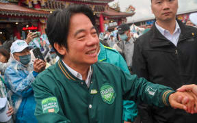 Taiwan's ruling Democratic Progressive Party (DPP) presidential candidate Lai Ching-te greets supporters during a campaign rally ahead of the January 2024 presidential election in Yilan county on December 21, 2023. (Photo by Sam Yeh / AFP)