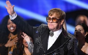 Elton John waves to fans on stage during the "Elton John: I'm Still Standing - A GRAMMY Salute" concert at The Theater at Madison Square Garden in New York.