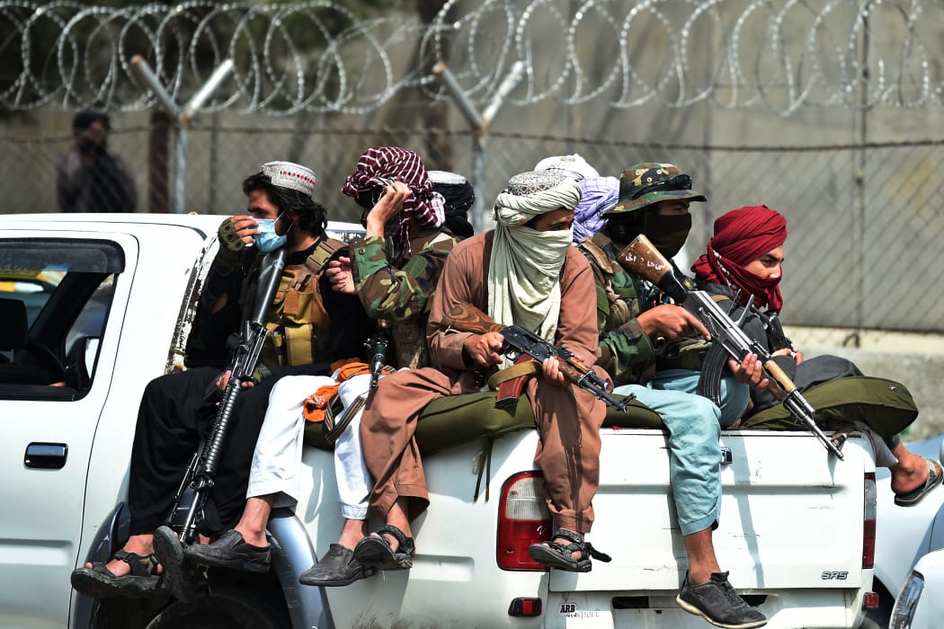 Taliban fighters guard outside the airport in Kabul on August 31, 2021