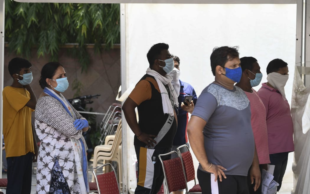 People wait to be tested for Covid-19 in New Delhi, India on 16 June 2020.