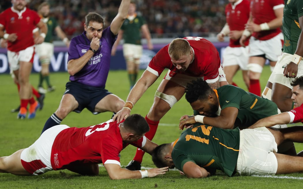 South Africa's centre Damian De Allende (C) is congratulated by teammates after scoring a try during the Japan 2019 Rugby World Cup semi-final match between Wales and South Africa.