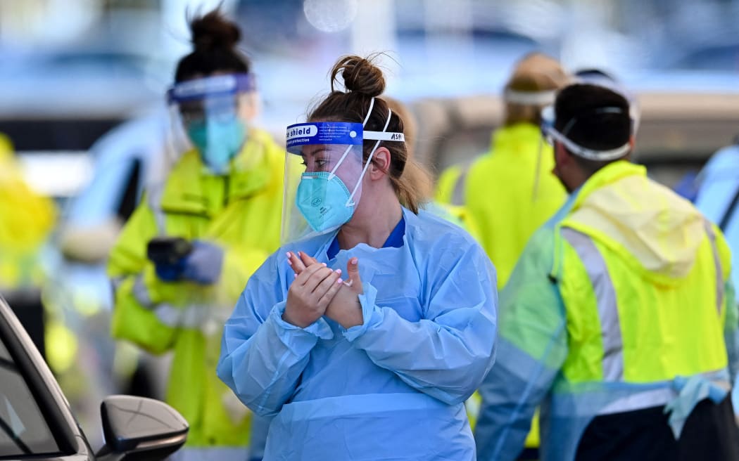 Health workers conduct Covid-19 tests at the St. Vincents Hospital drive-through testing clinic at Bondi Beach in Sydney 27 June, 2021.