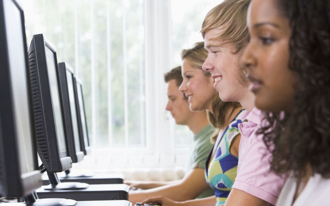 Teenage students using computers, generic