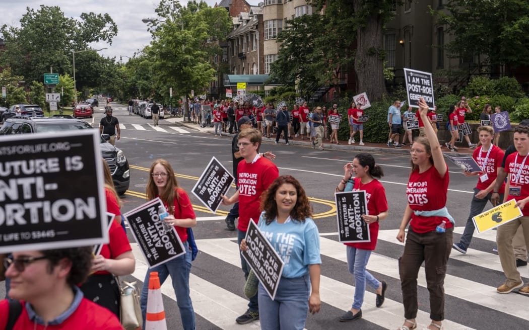 WASHINGTON, DC - JUNE 24: Anti-abortion activists demonstrate in front of the U.S. Supreme Court after the Court announced a ruling in the Dobbs v Jackson Women's Health Organization case on June 24, 2022 in Washington, DC. The Court's decision in the Dobbs v Jackson Women's Health case overturns the landmark 50-year-old Roe v Wade case, removing a federal right to an abortion.   Nathan Howard/Getty Images/AFP (Photo by Nathan Howard / GETTY IMAGES NORTH AMERICA / Getty Images via AFP)