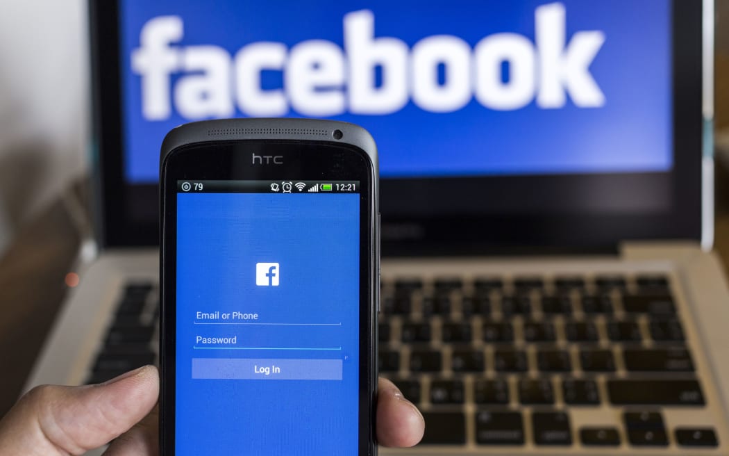 CHIANG MAI, THAILAND - OCTOBER 21, 2014: Facebook application sign in page on smartphone and facebook logo on background.