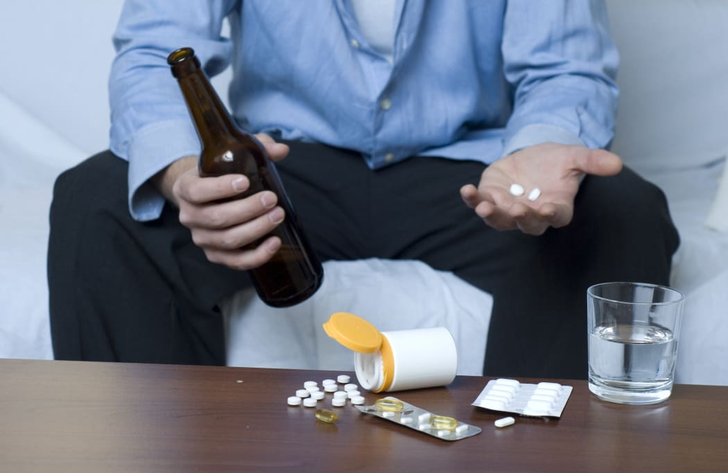15915182 - businessman doing mixed use of drugs and alcohol.