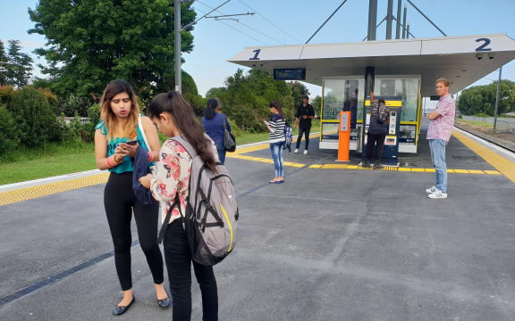 Stranded passengers await for updates on the train situation at Takanini train station.