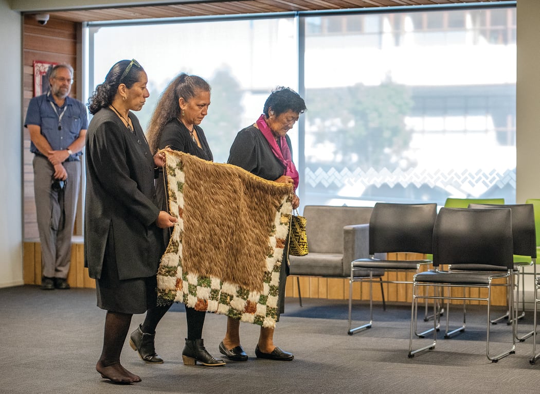Te Papa Tongarewa kaimahi Lisa Osborne and Moana Parata with Tūhoe kuia Lucy Hona carry the kahu huruhuru which was stolen from prophet Rua Kēnana’s daughter Pinepine in a police raid over 100 years ago.