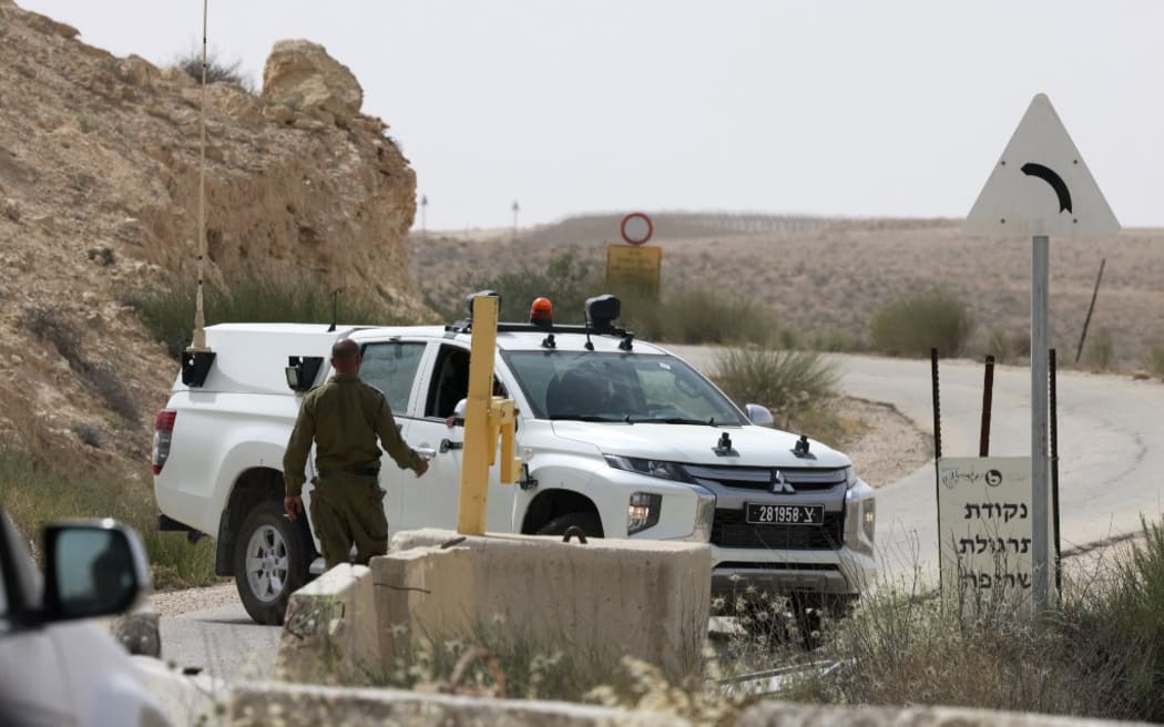 An Israeli soldier walks up to a military vehicle close to the Mount Harif military base near the city of Mitzpe Ramon in Israel's southern Negev desert, adjacent to the border with Egypt, on June 3, 2023.