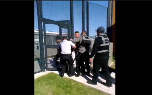 A New Zealand mother of six says guards used excessive force against her.