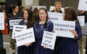 Children join a protest calling for a government inquiry into Gloriavale