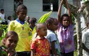 The children of Nawaisomo in the Fiji highlands are getting used to choppers landing in their remote village