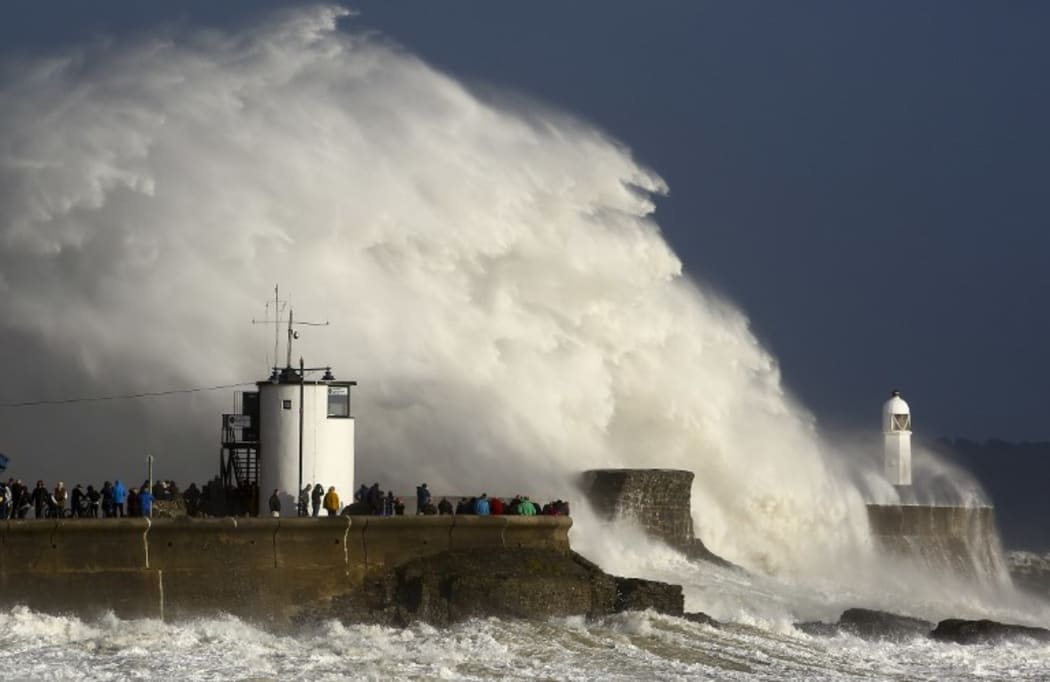 Huge waves strike the harbour wall and lighthouse at Porthcawl, South Wales, as storm Ophelia hits.