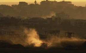 An Israeli army tank manoeuvres in the Gaza Strip as seen from southern Israel on 4 May 2025.