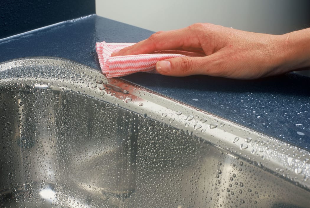 female hand with dish cloth
