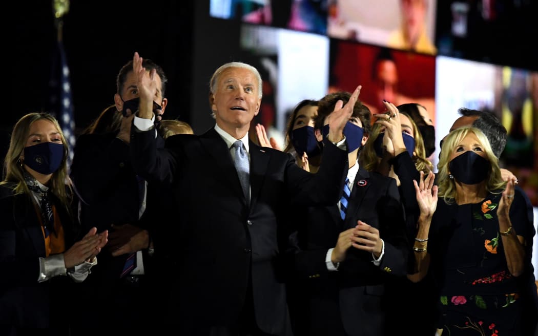 US President-elect Joe Biden with his wife Jill Biden, alongside family members, watch fireworks after he delivered his victory speech in the 2020 US Presidential election.