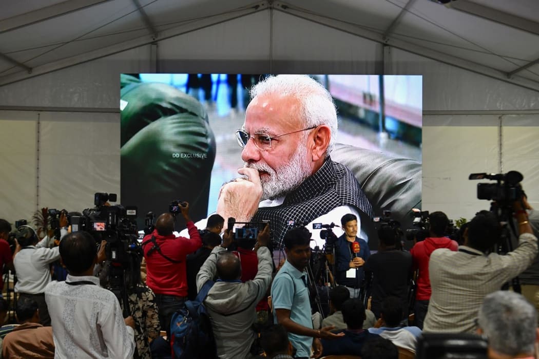 India's Prime Minister Narendra Modi is seen on a TV screen as he watches the live broadcast of the attempted moon landing of spacecraft Vikram Lander of Chandrayaan-2.