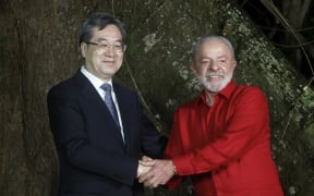 Brazil's President Luiz Inacio Lula da Silva (R) and China's Deputy Prime Minister Ding Xuexiang greet during a meeting in Belem, Para state, Brazil, on 5 November, 2025. Lula da Silva is preparing to host the COP30 UN climate summit next November 10 to 21, in Belem.