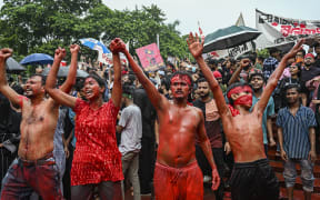 Activists are performing drama while taking part in a protest march against Prime Minister Sheikh Hasina and her government to demand justice for more than 200 people killed in last month's violent demonstrations in Dhaka, Bangladesh, on August 2, 2024. (Photo by Zabed Hasnain Chowdhury/NurPhoto) (Photo by Zabed Hasnain Chowdhury / NurPhoto / NurPhoto via AFP)