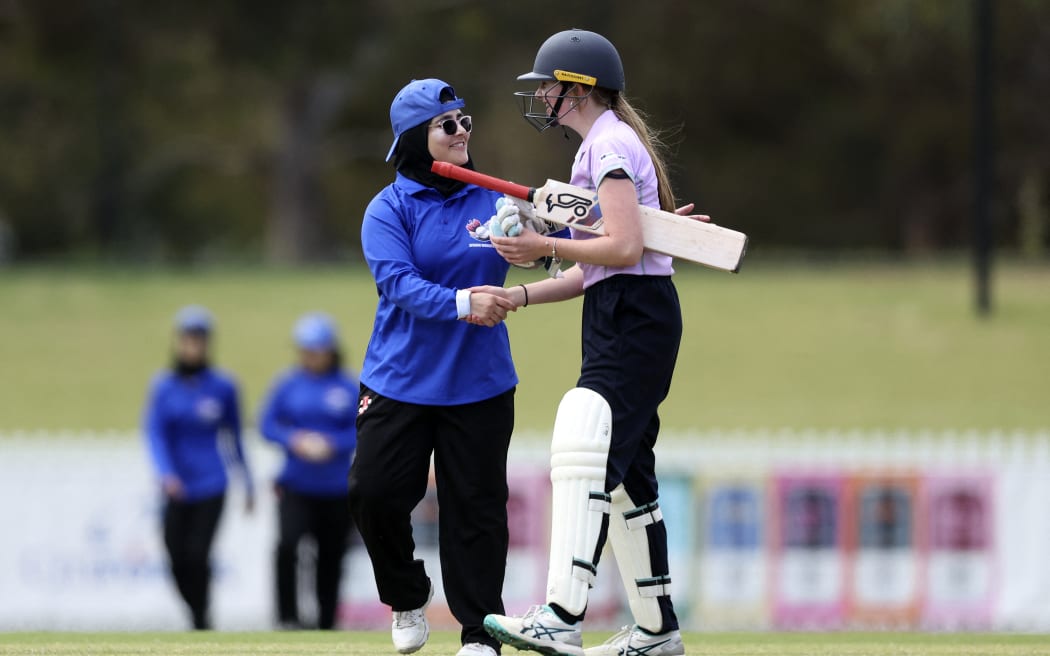 Players from the Afghanistan Women's XI and Cricket Without Borders XI shake hands at at Junction Oval in Melbourne on January 30, 2025. Afghanistan's women cricketers played their first game since fleeing the Taliban three years ago.