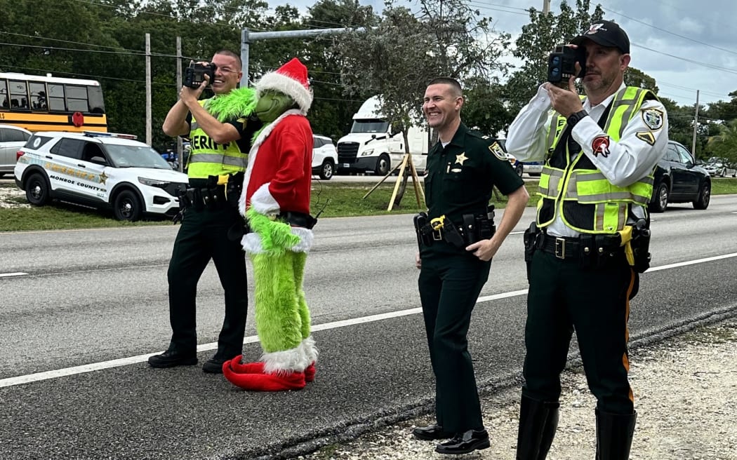The grumpy ole' Grinch (who may double sometimes as Monroe County Sheriff's Office's Colonel Lou Caputo) was back out and about Friday, handing out onions and warnings to motorists and making friends at area schools.